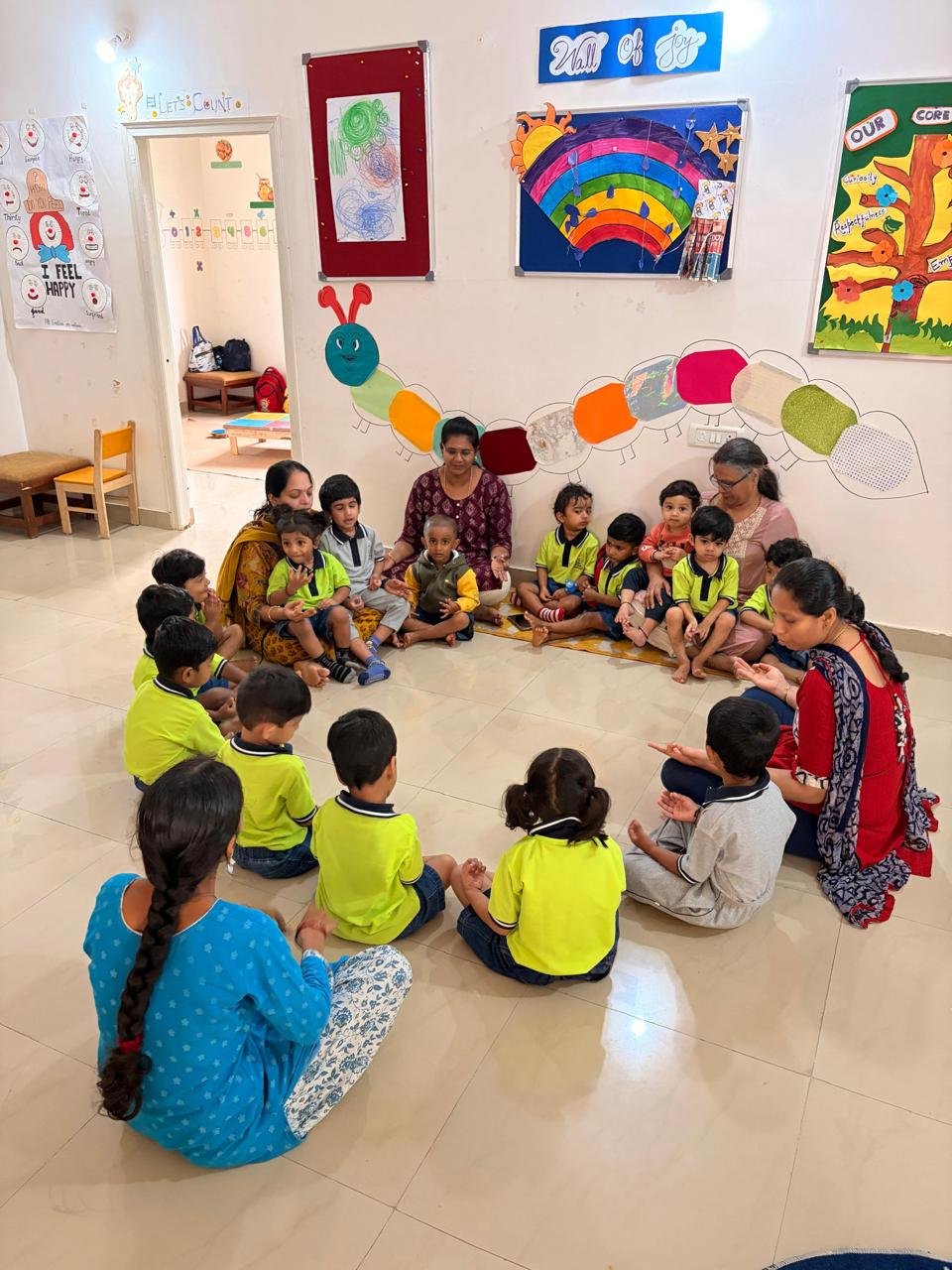 Arka children and educators seated together in a circle