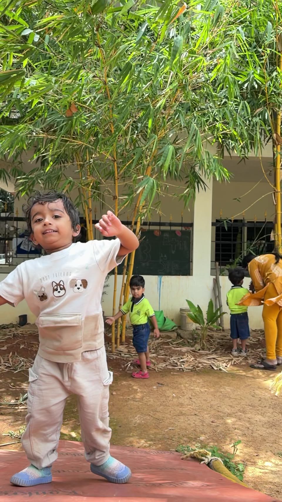 An Arka child enjoying movement beneath the bamboo